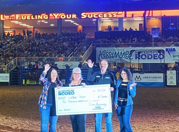 Bella, Jill, and Gary accepting a charitable check donated by the Silver Spurs Rodeo